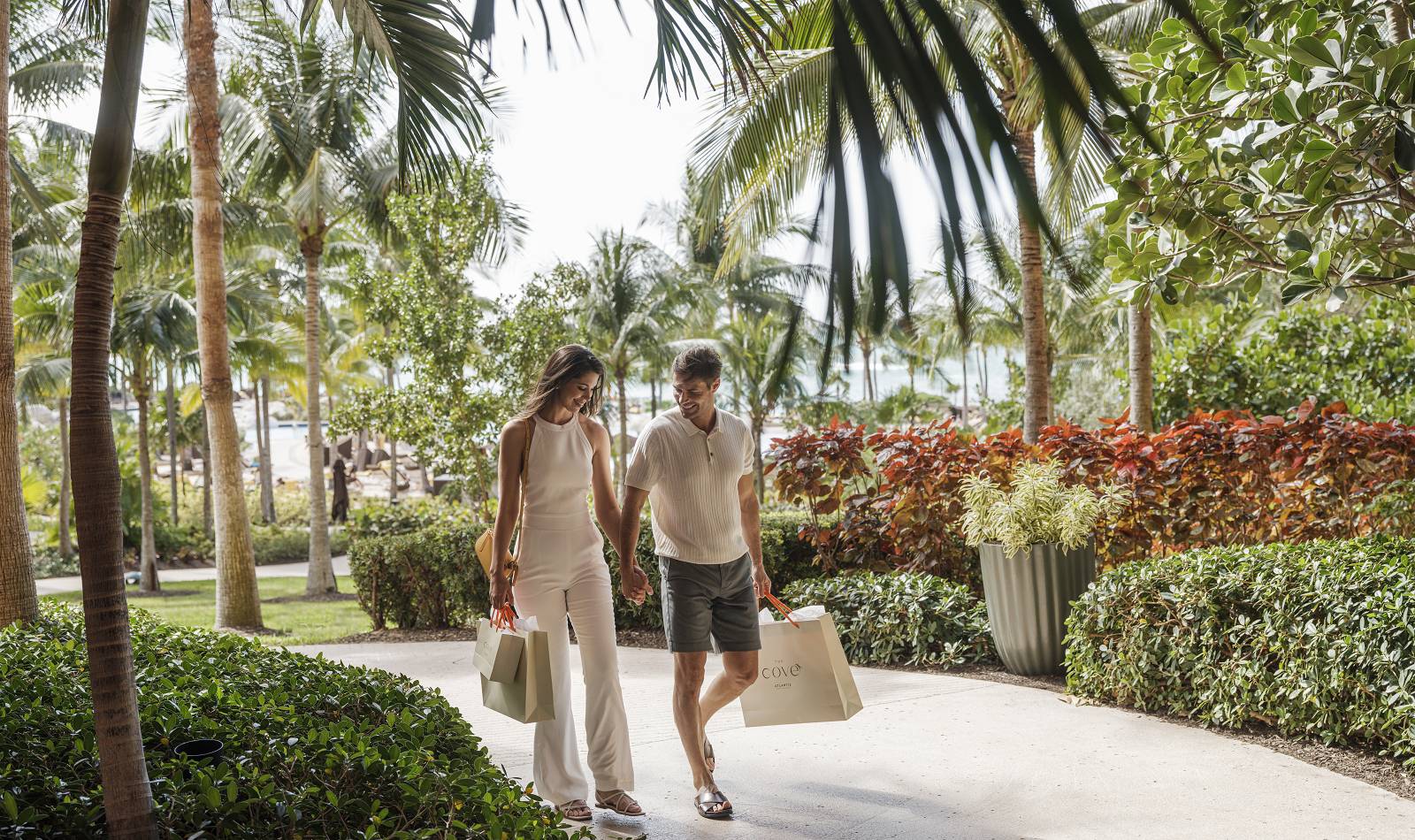 the cove couple with shopping bags on pathway