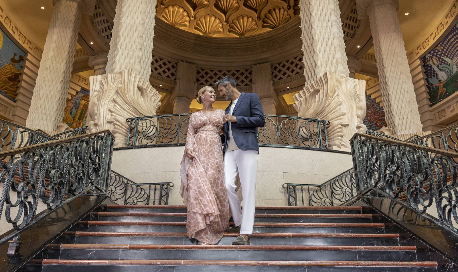 atlantis the royal lobby staircase couple walking